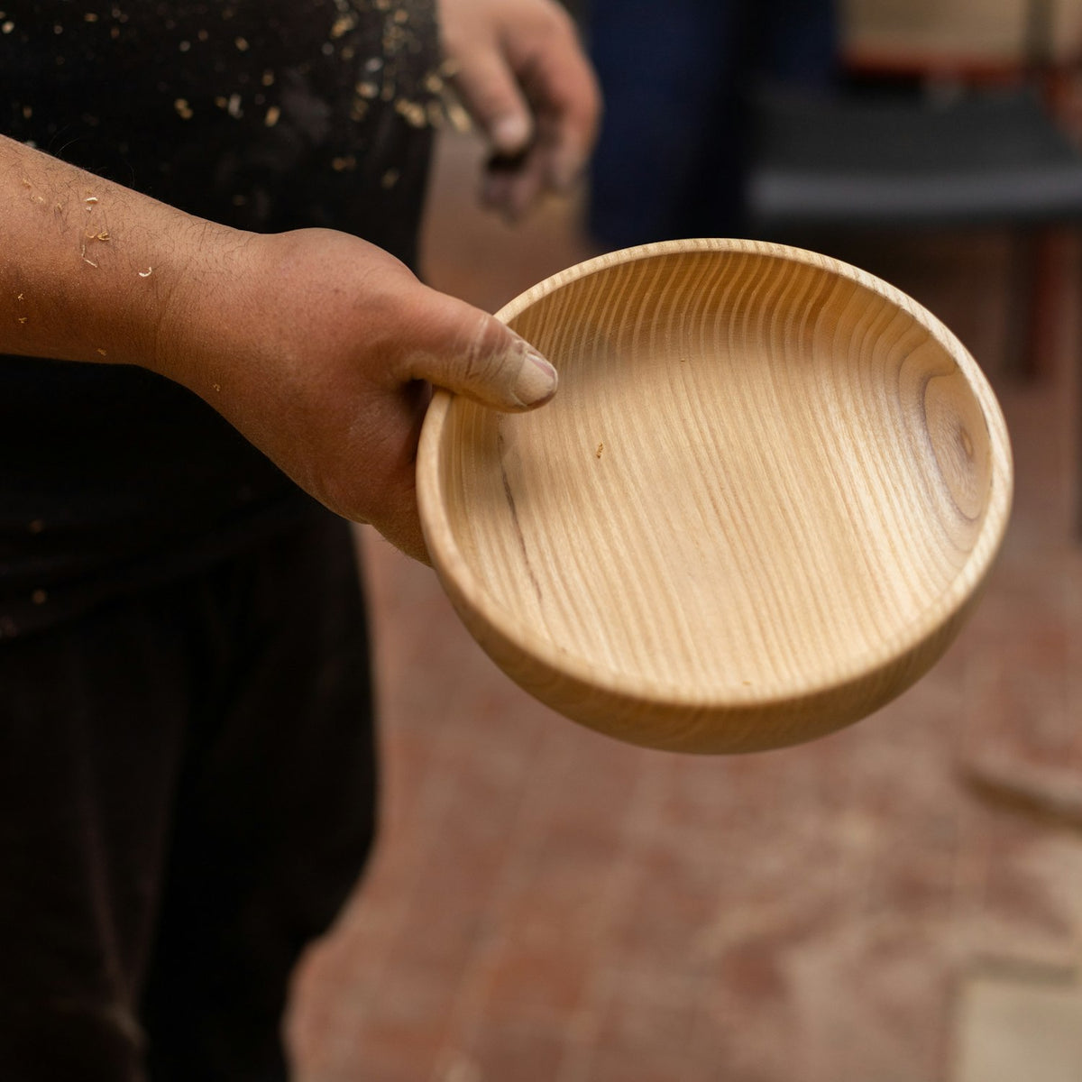 pkholdingbowl A person holding a carved wooden kava bowl